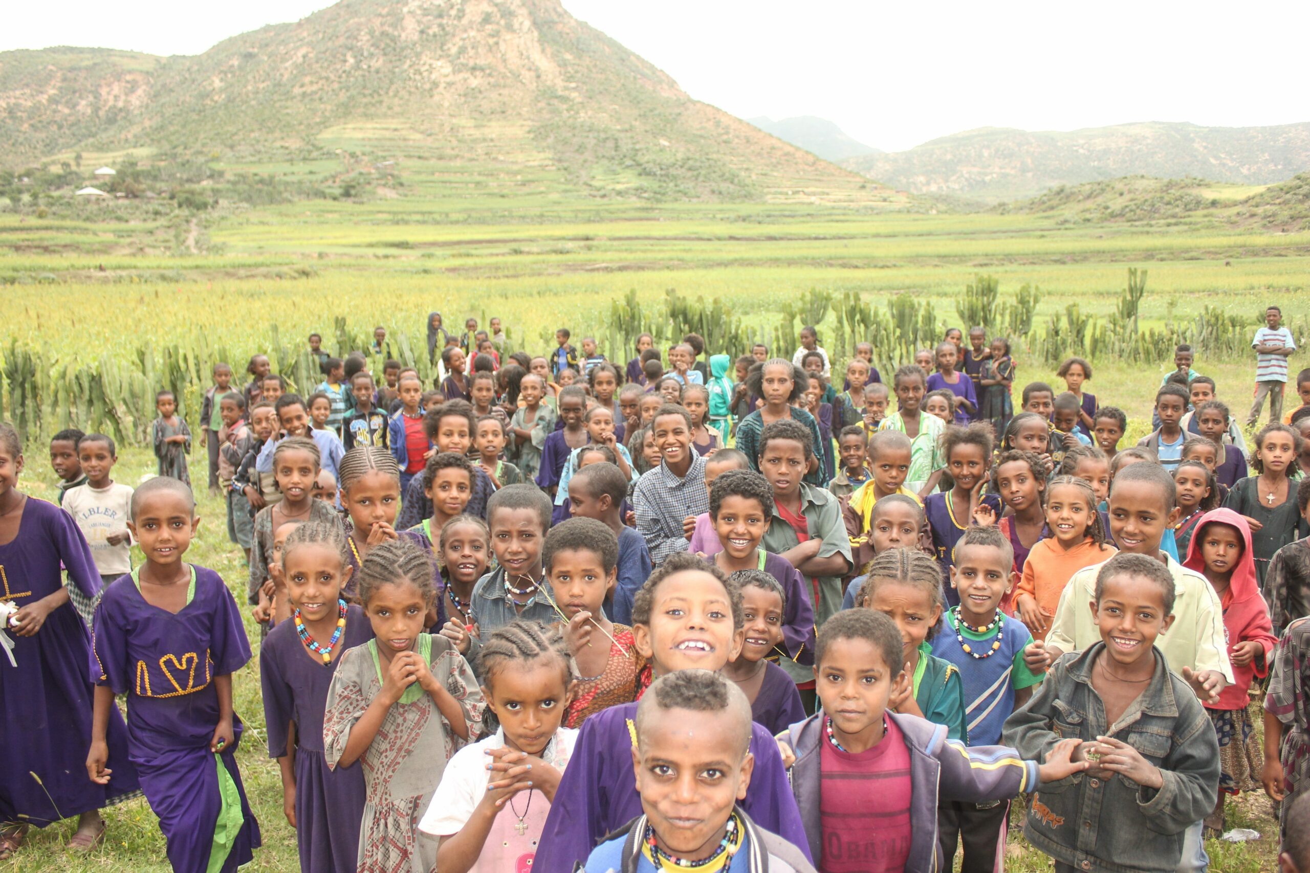 Young children stand in a field in Atsemba, Ethiopia.