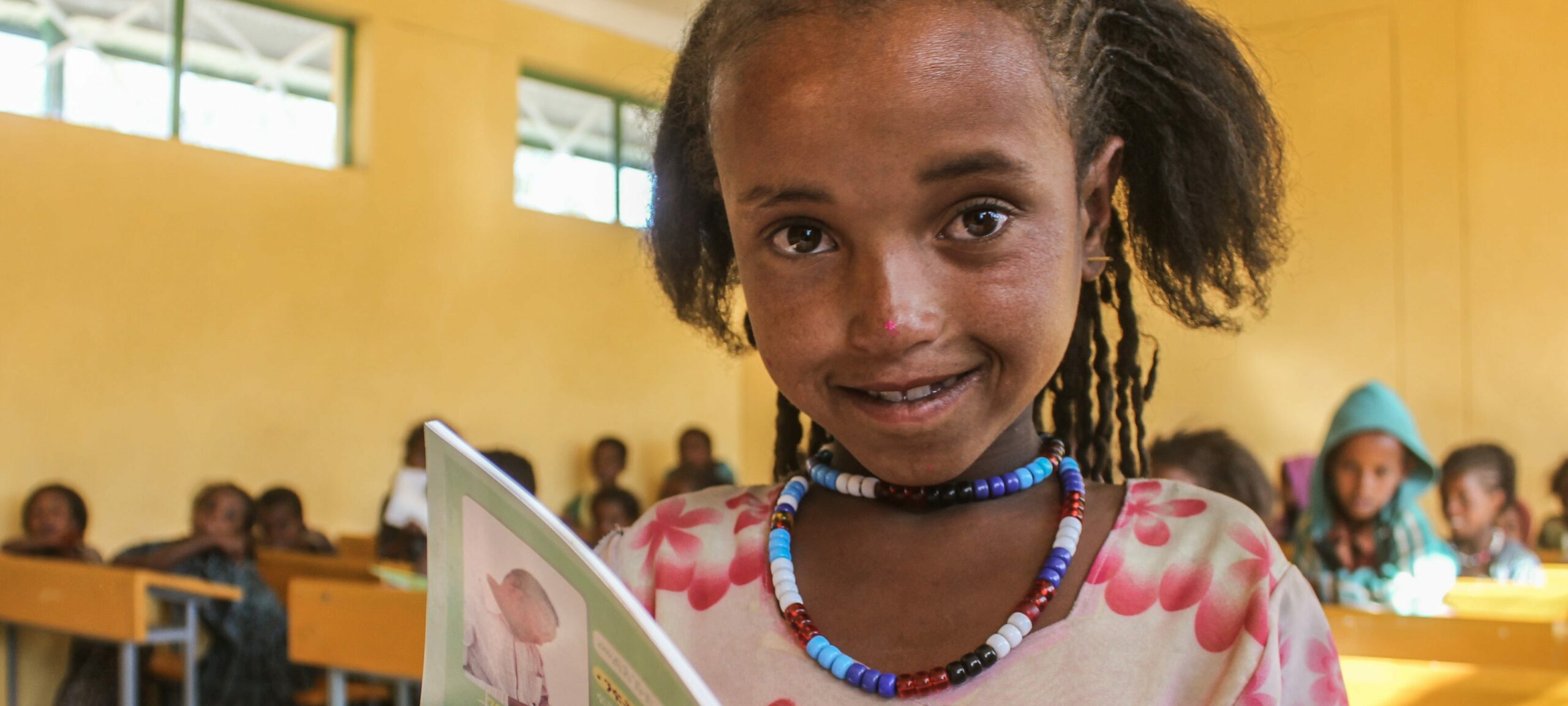 A young girl reading a book in the new Gereb Abdela Primary School in Ethiopia.