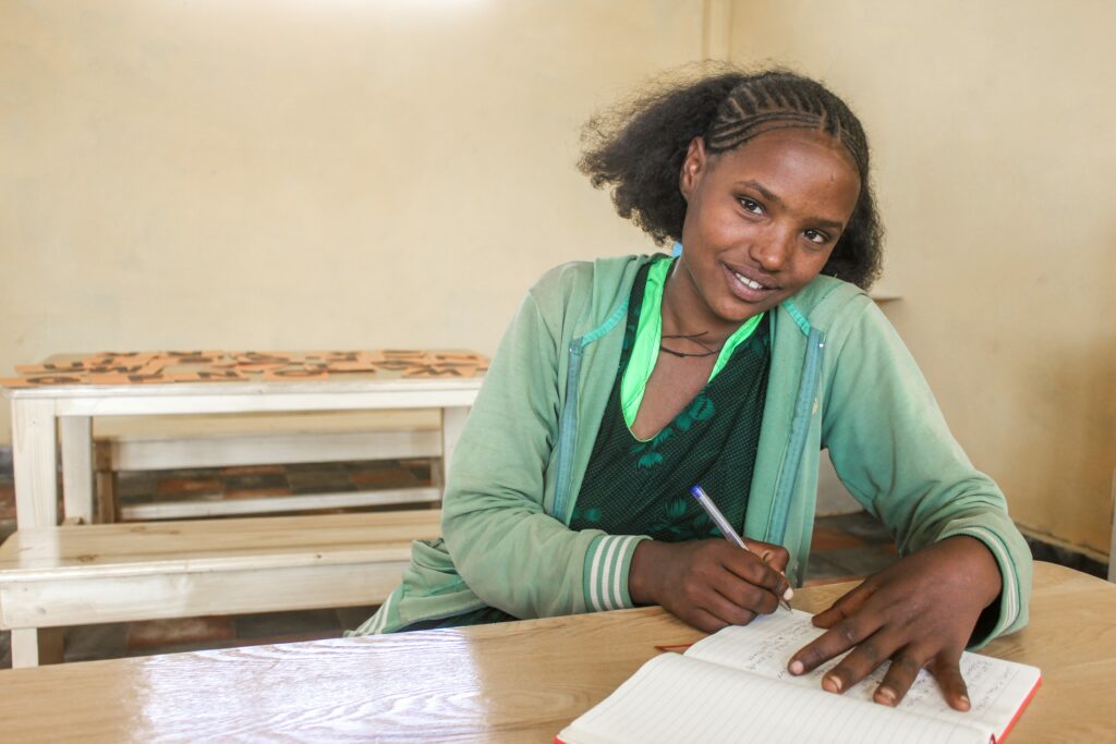 Mulu Gashaye sitting at her desk in her new school.