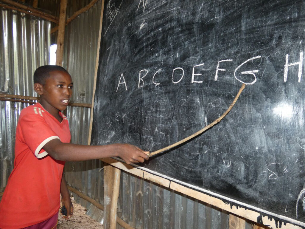 A boy coping with displacement trauma via access to Accelerated Primary Learning Program
